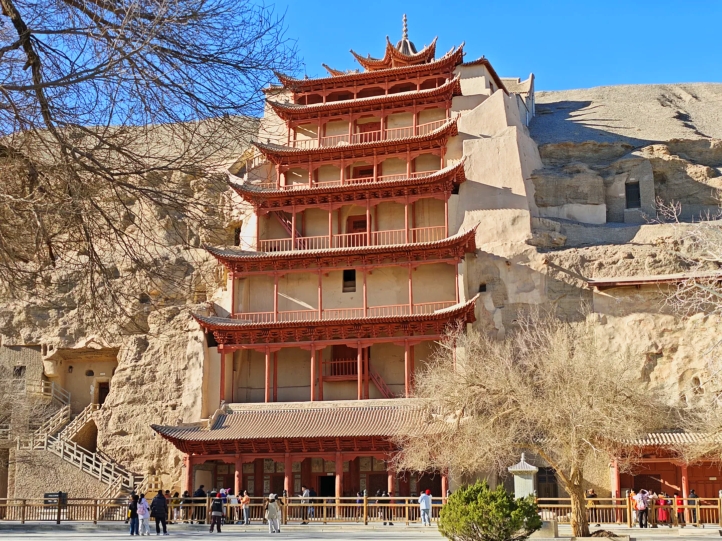 The Mogao cliff from outside. Exchange the passport for the paper ticket at the Digital Exhibition Center, not at the caves.
